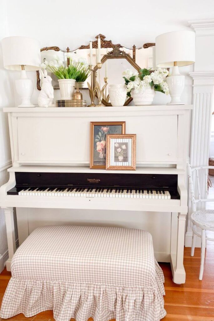 After photo of antique piano painted with a creamy white paint color and a new ruffled gingham bench.