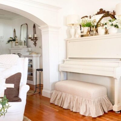 Cottage style piano makeover with creamy white painted upright piano and gingham bench