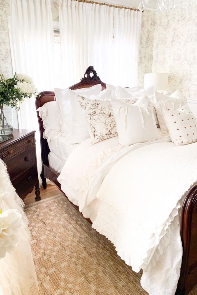Romantic cottage bedroom with soft off-white sheets and textured ruffle details