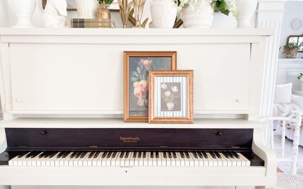 Close view of creamy white painted piano with original Farrand Piano Company label preserved