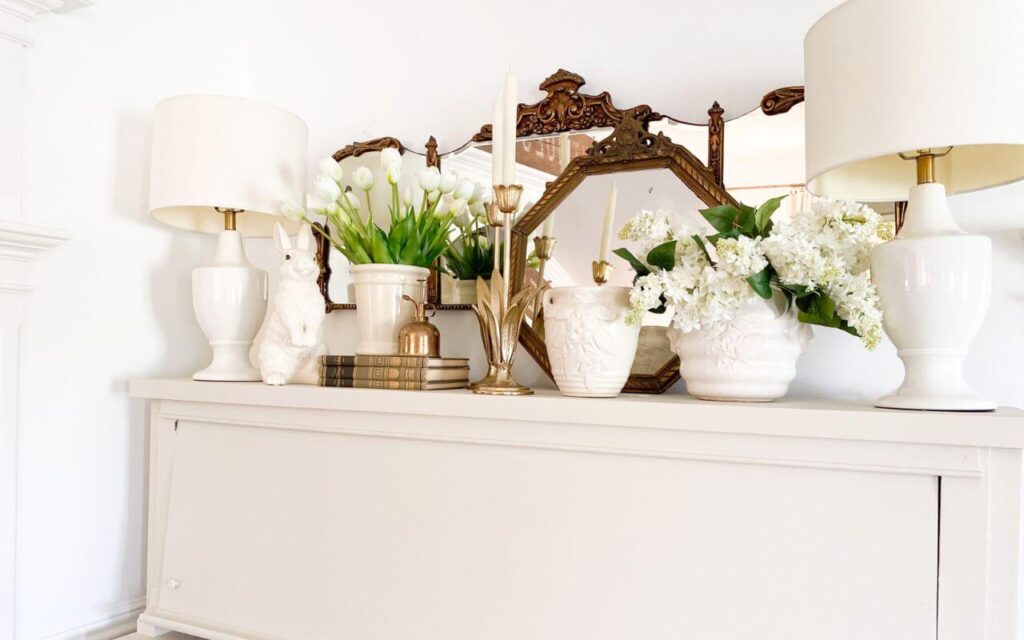 Painted piano styled with antique gold mirror, spring white flowers, brass tulip candelabras and antique McCoy vases.