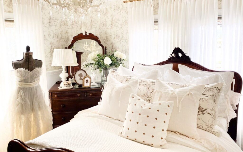 Close-up of ruffled cotton coverlet and ruffled euro shams layered on a cottage bed