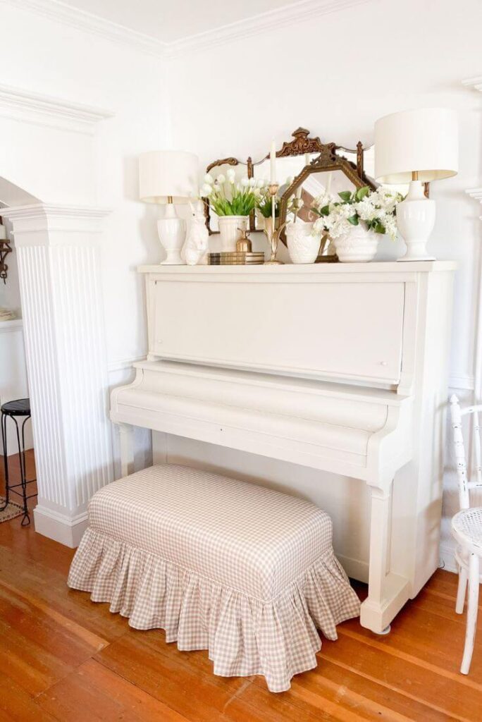 Upright antique piano that received a make-over and is styled with vintage finds and antique mirrors.