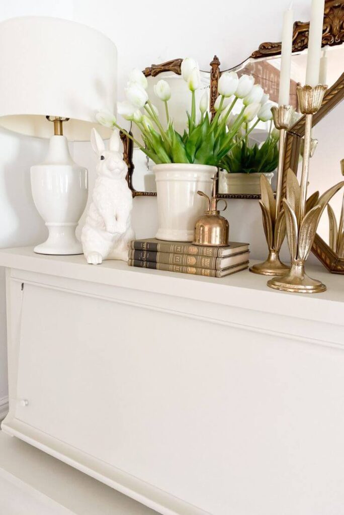 Antique painted piano styled for spring with bunnies, tulips and white antique vases.