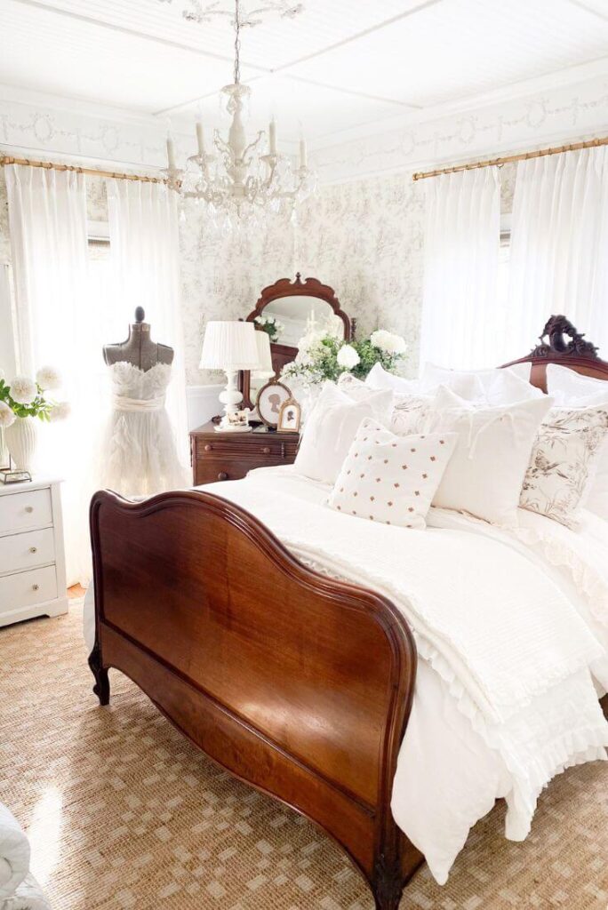 Vintage-inspired bedroom with layered pillows, curtains, and textured linens