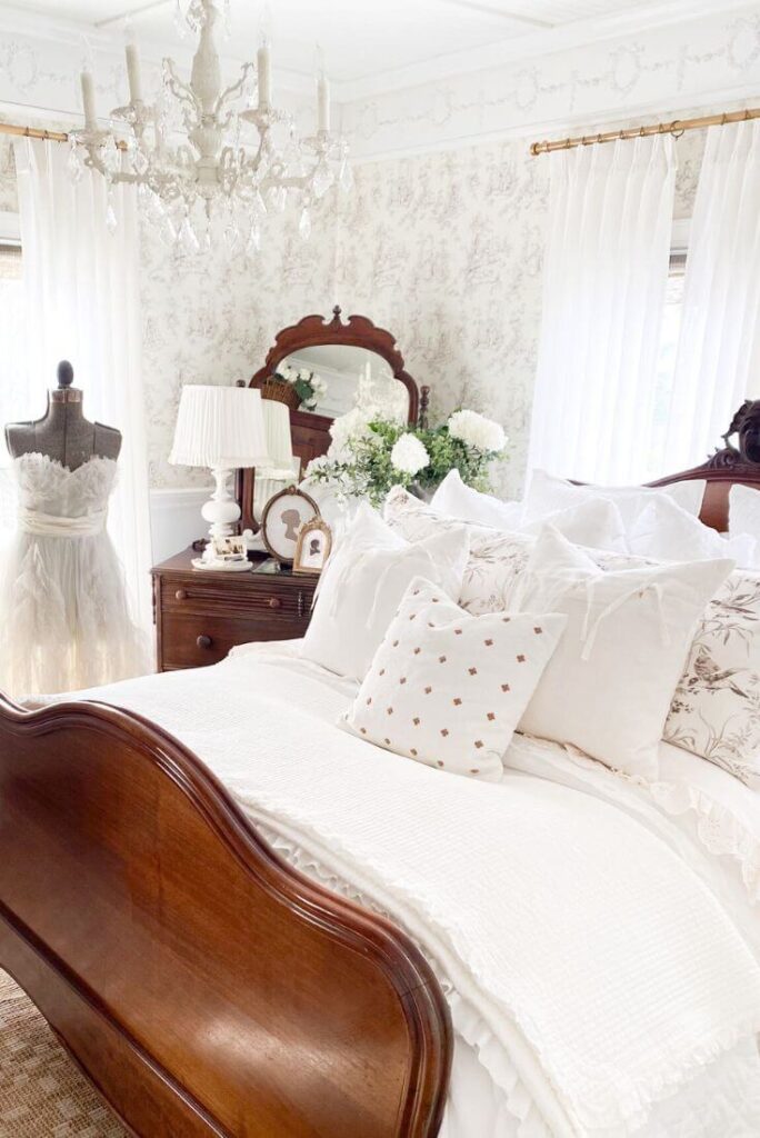 Cottage-style bedroom featuring vintage furniture and soft gathered bedding