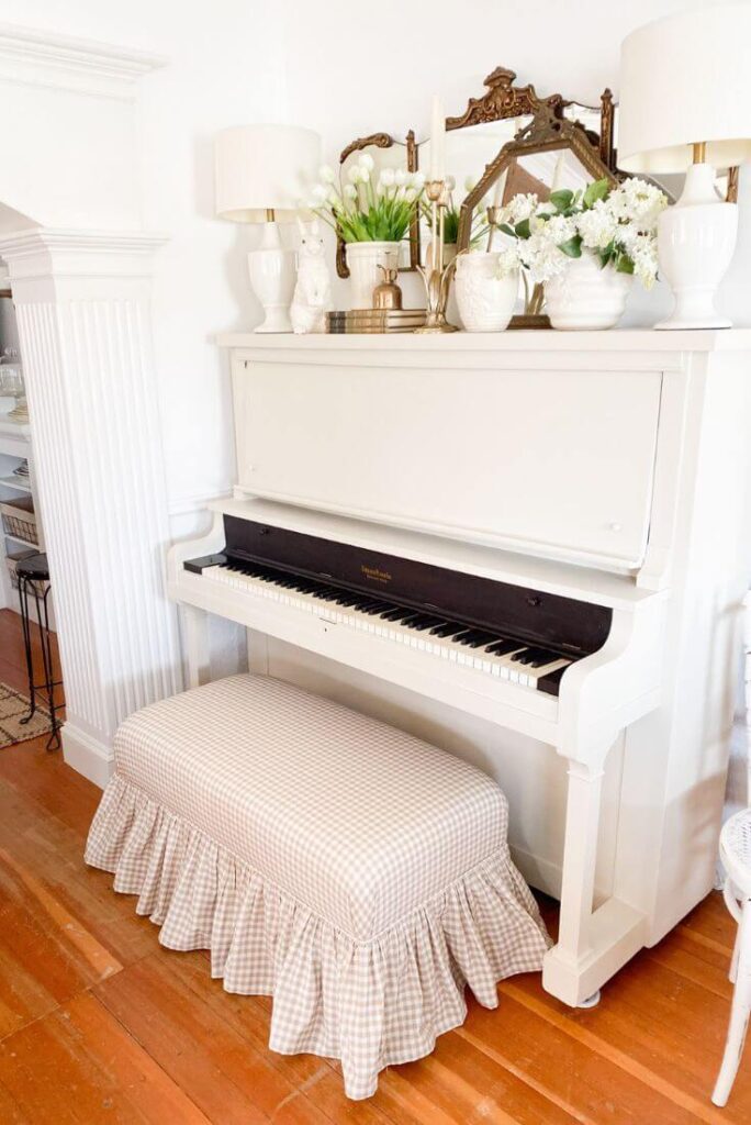 Antique piano painted cream with chalk paint and styled with vintage mirrors, McCoy vases and spring florals.