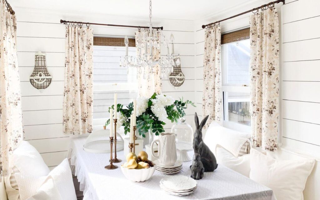 Handmade DIY kitchen curtains with floral fabric in a breakfast nook