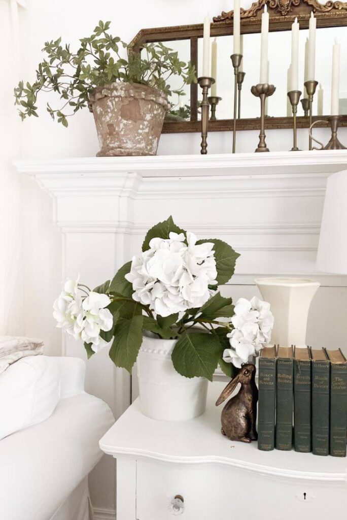 Realistic faux hydrangea plant in white ceramic pot.