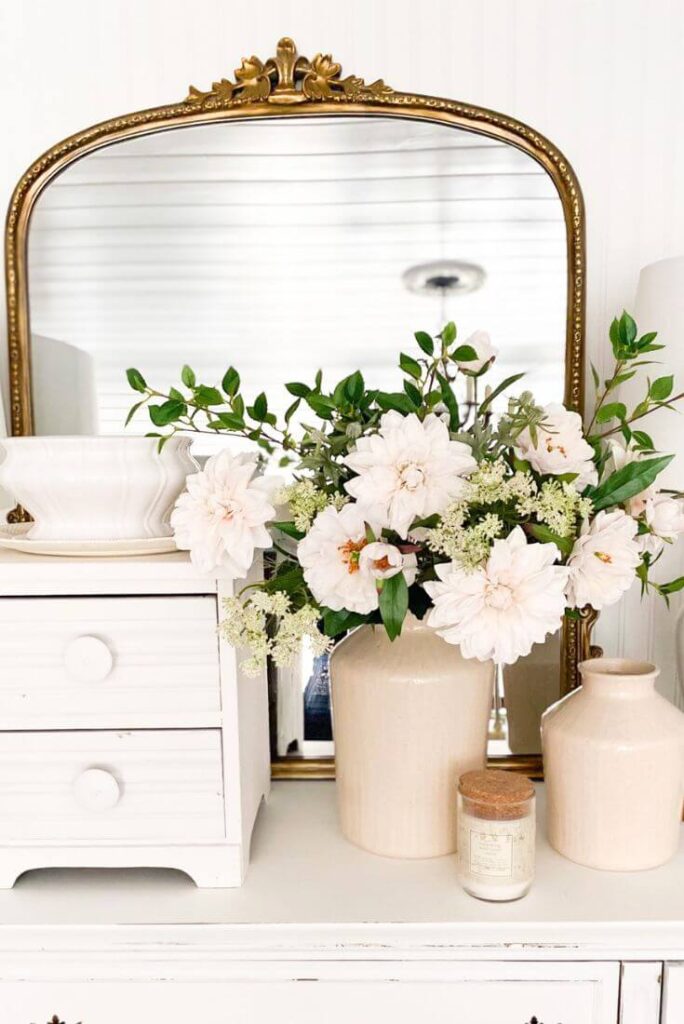 Cottage style spring florals and a gold mirror.