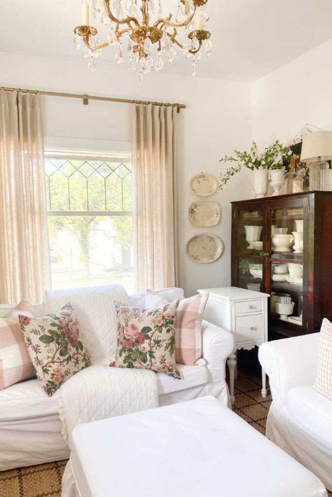 Cottage living room refresh with floral and pink buffalo check pillows