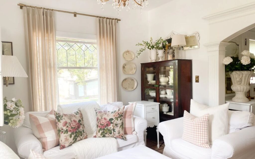 ink gingham and floral throw pillows layered on a white cottage-style sofa